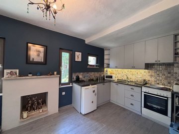 A Traditional Garden Apartment With Modern Accents Is For Sale In Dalyan - Fully fitted modern kitchen and fireplace